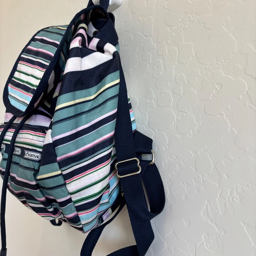 LeSportsac Voyager drawstring backpack in a navy pastel stripe pattern.